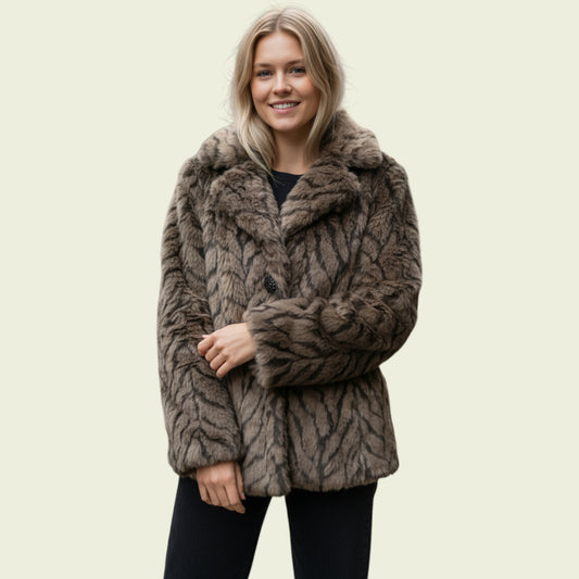 Woman wearing a fur coat on a beige background