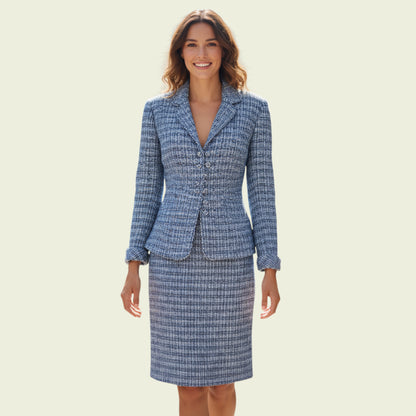 Woman wearing a blue checkered suit on a beige background