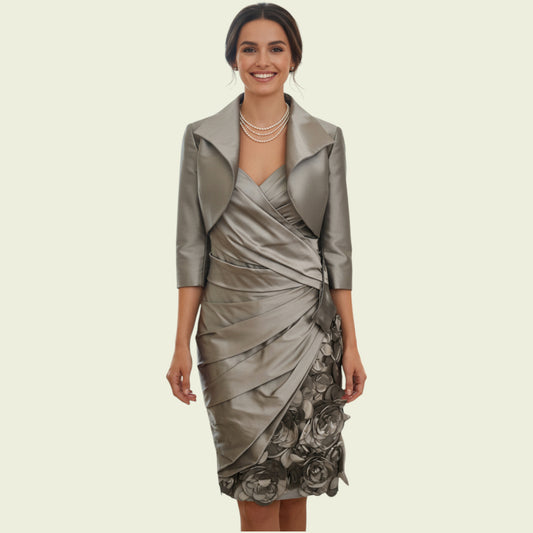 Woman wearing a silver dress with a matching jacket on a beige background