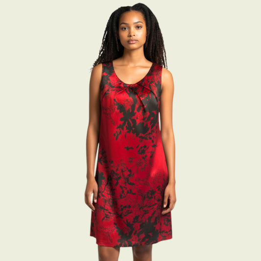 Woman wearing a red and black patterned dress on a beige background