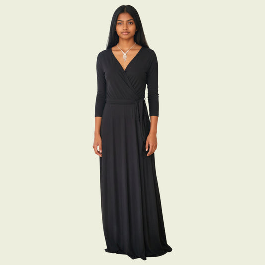 Woman wearing a black long-sleeve gown on a beige background