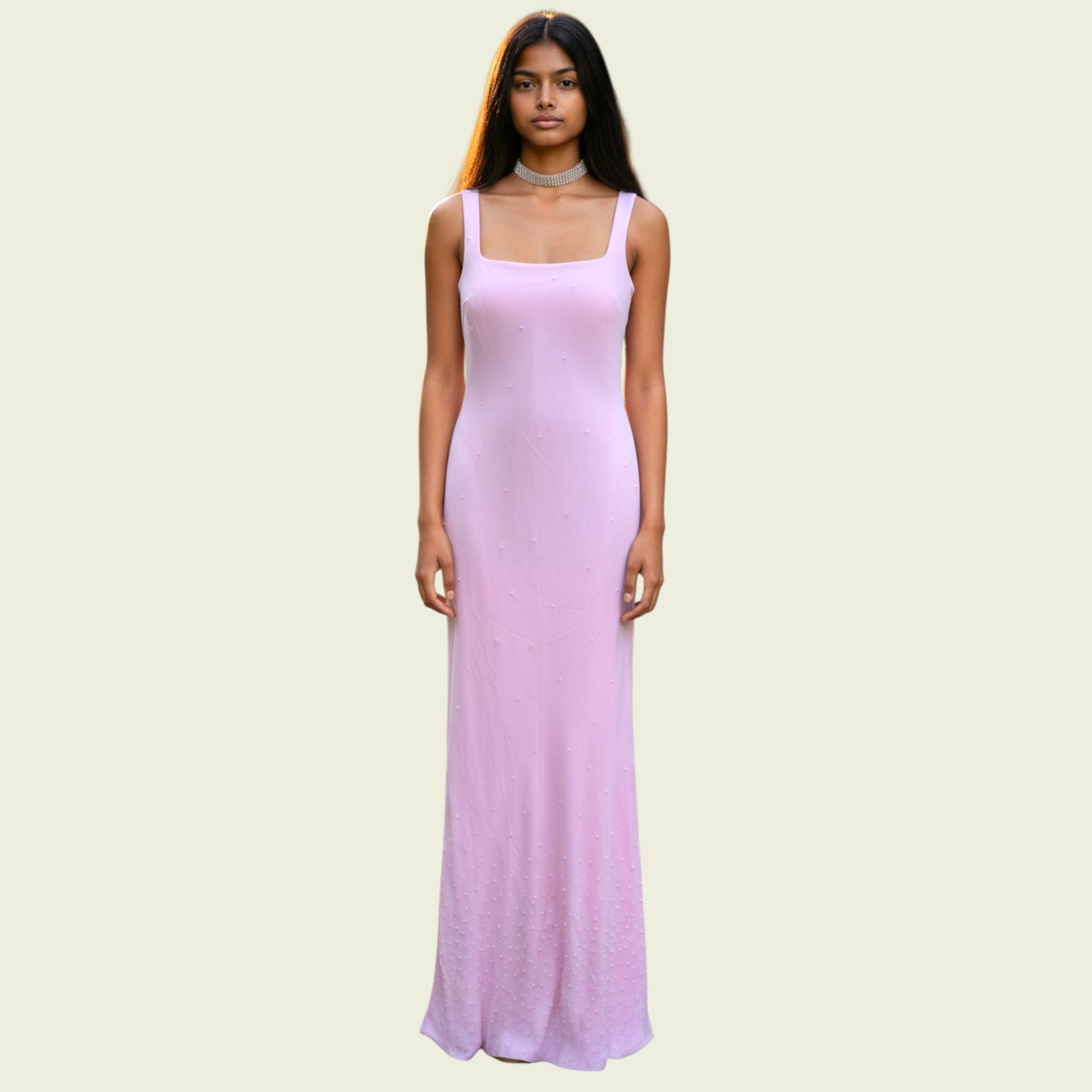 Woman wearing a long pink dress on a light beige background