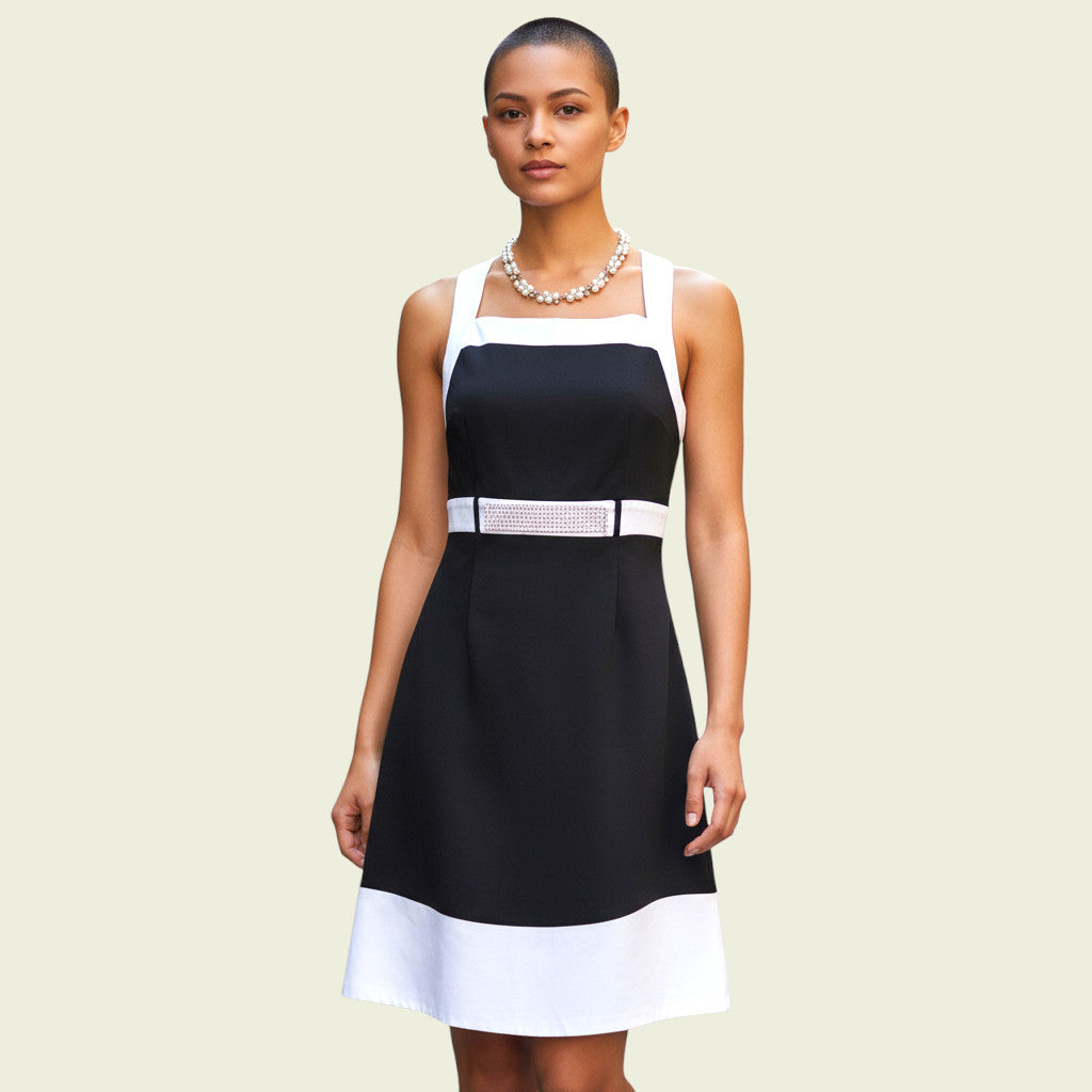 Model wearing black and white dress with diamante detail