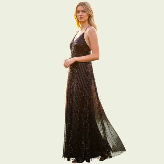 Woman wearing a black sequin evening gown on a light beige background