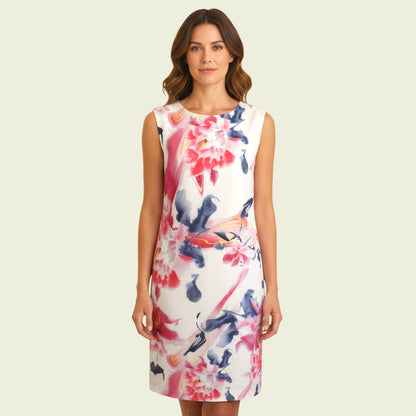 Model wearing white and multicoloured floral dress on beige background