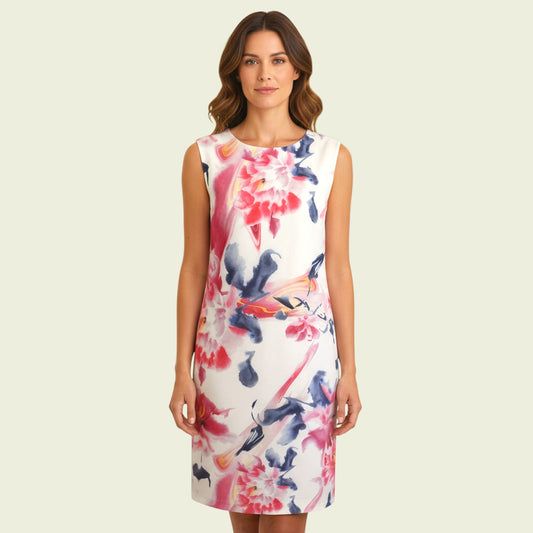 Model wearing white and multicoloured floral dress on beige background