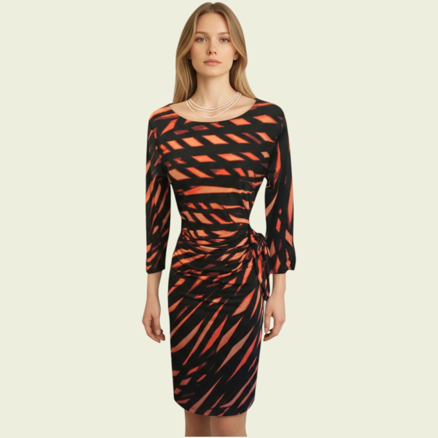 Woman wearing a black and orange patterned dress on a beige background