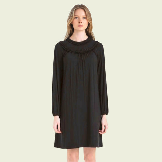 Woman wearing a black dress on a beige background