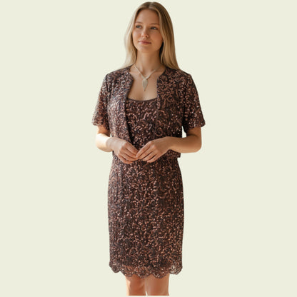 Woman wearing a sequinned dress and jacket set on a beige background