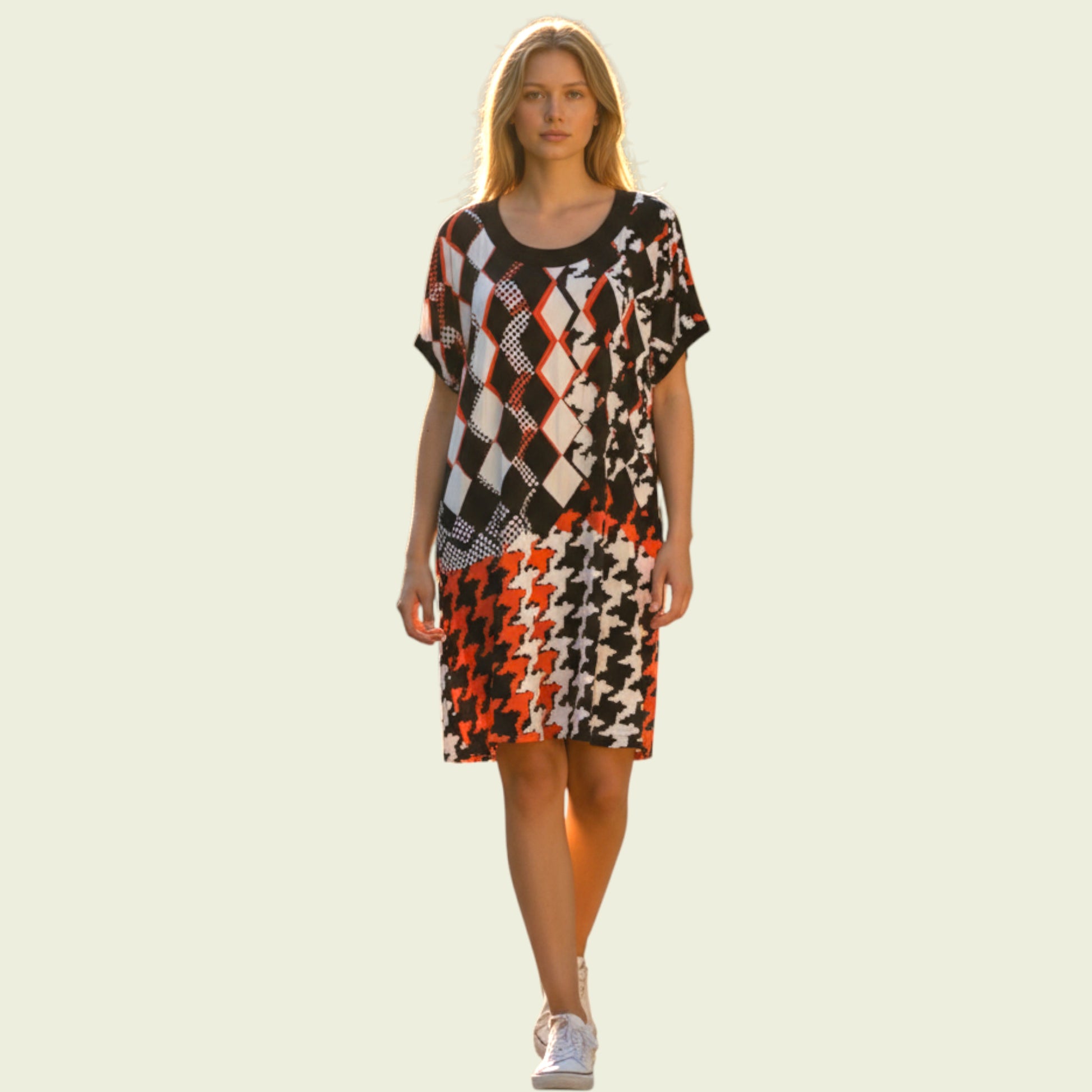 Woman wearing a patterned dress on a light background