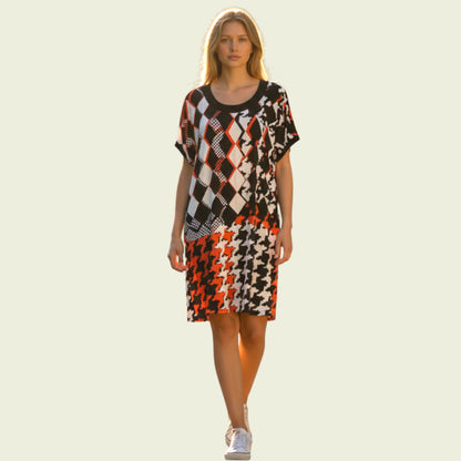 Woman wearing a patterned dress on a light background