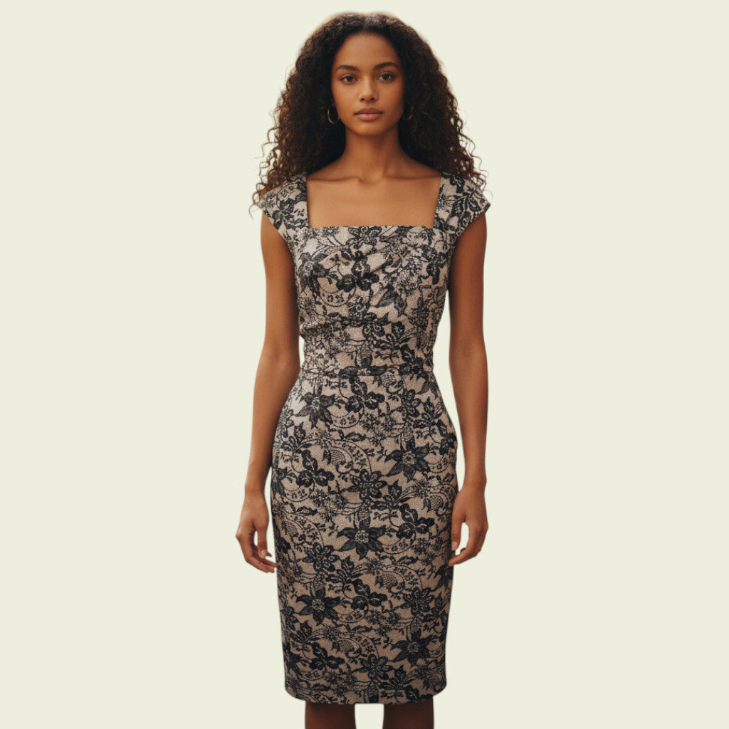 Model wearing cream and black lace dress on beige background