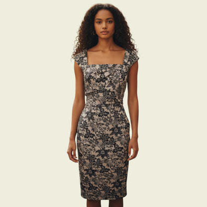 Model wearing cream and black lace dress on beige background