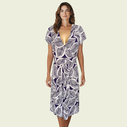 Model wearing a blue and white floral dress on a beige background