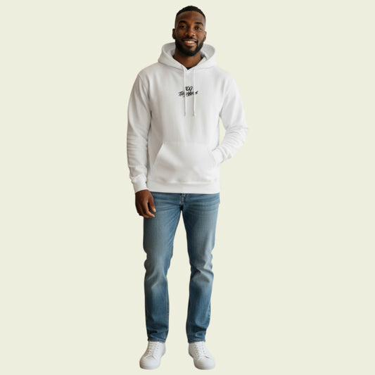 Man wearing a white hoodie and blue jeans on a beige background