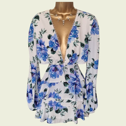 Mannequin wearing blue and white floral skater dress on beige background