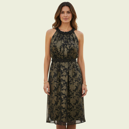 Woman wearing a black floral lace dress on a beige background