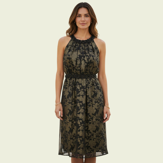 Woman wearing a black floral lace dress on a beige background