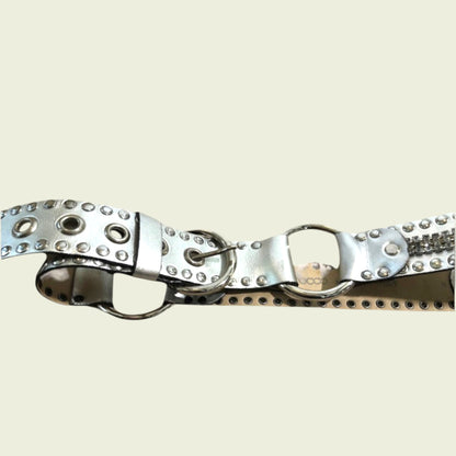 Metallic belt with studs on a beige background