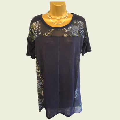 Navy blue dress with floral patterns on a mannequin against a light background