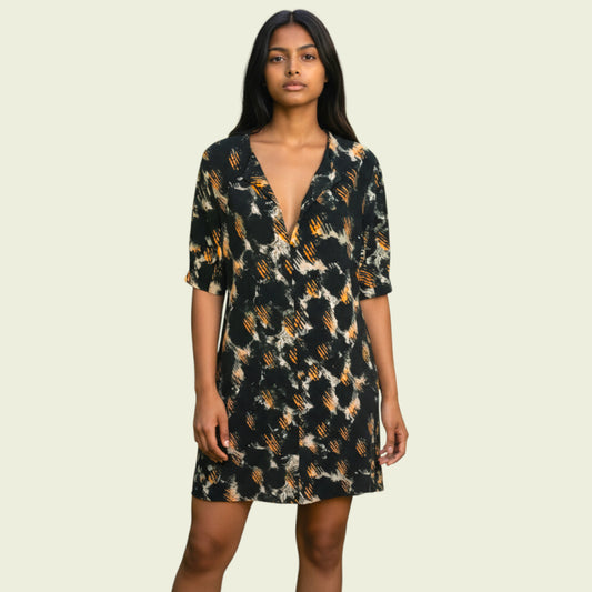 Woman wearing a patterned dress on a beige background