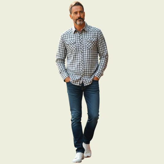Model wearing plaid shirt and jeans on a light background
