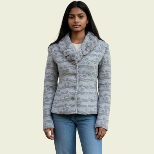 Woman wearing a patterned gray jacket on a beige background