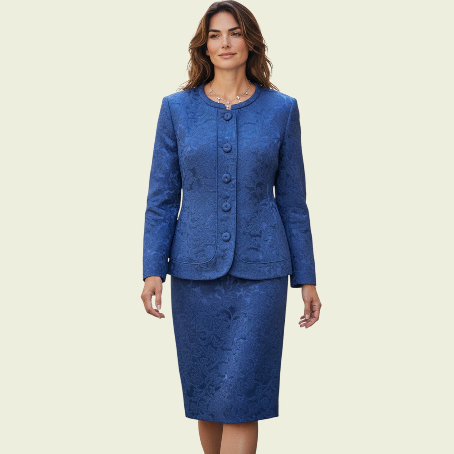 Model wearing a midnight blue dress and jacket set on a beige background