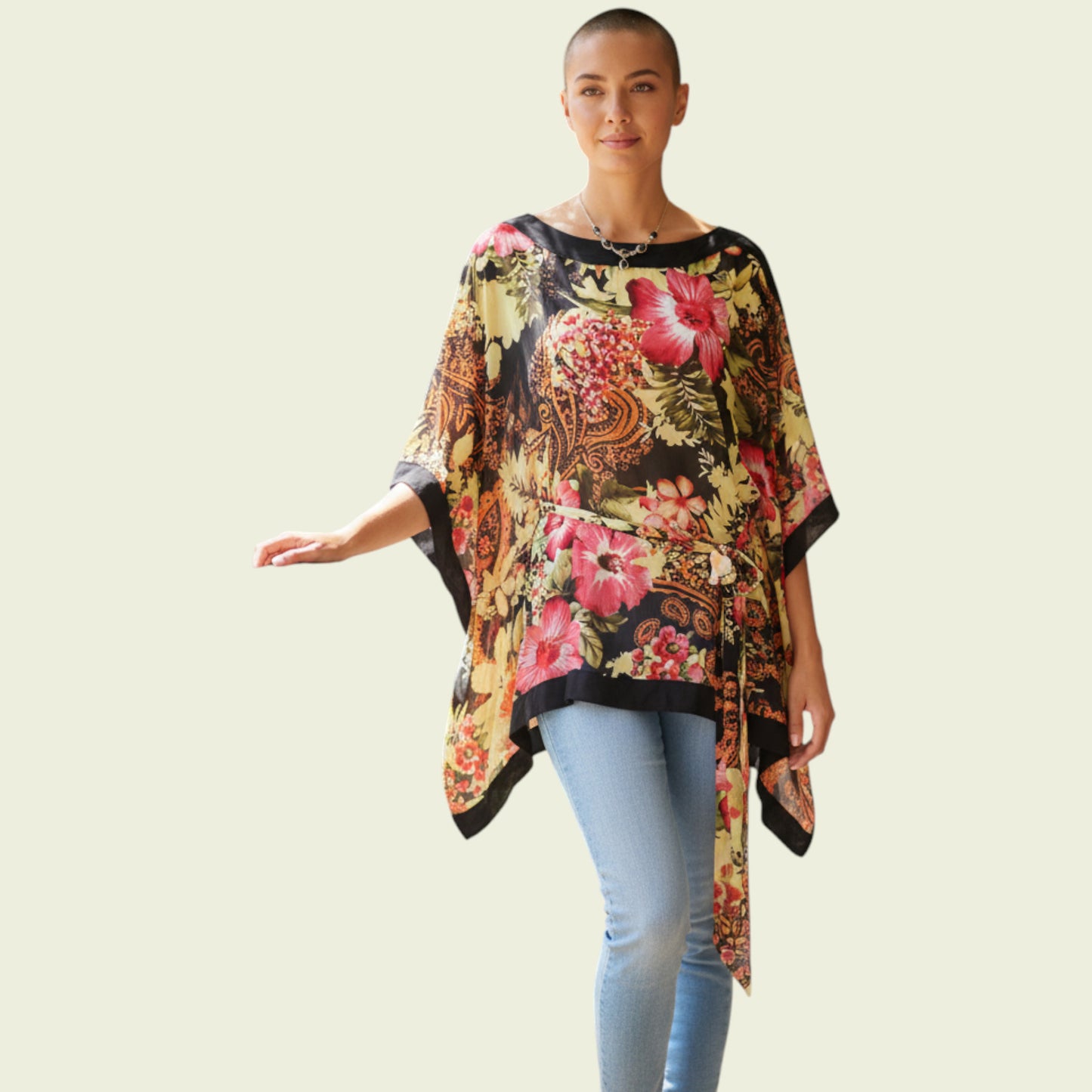 Model wearing floral tunic top on beige background