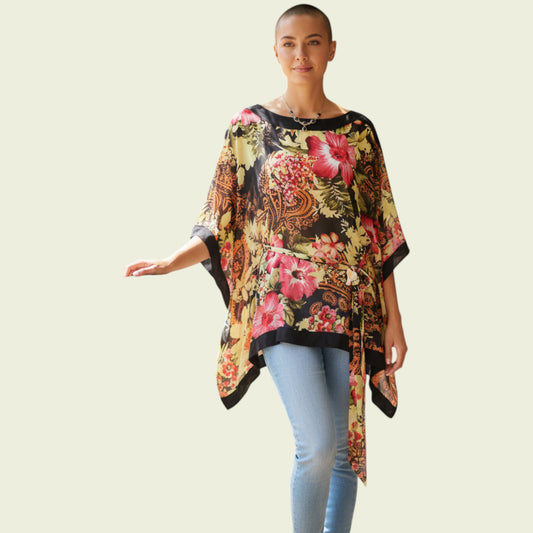 Model wearing floral tunic top on beige background