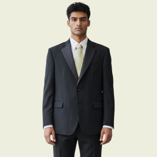 Man wearing a dark gray suit with a white shirt and patterned tie on a beige background