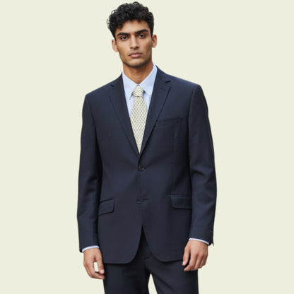 Man wearing a dark blue jacket with a light blue shirt and patterned tie on a beige background