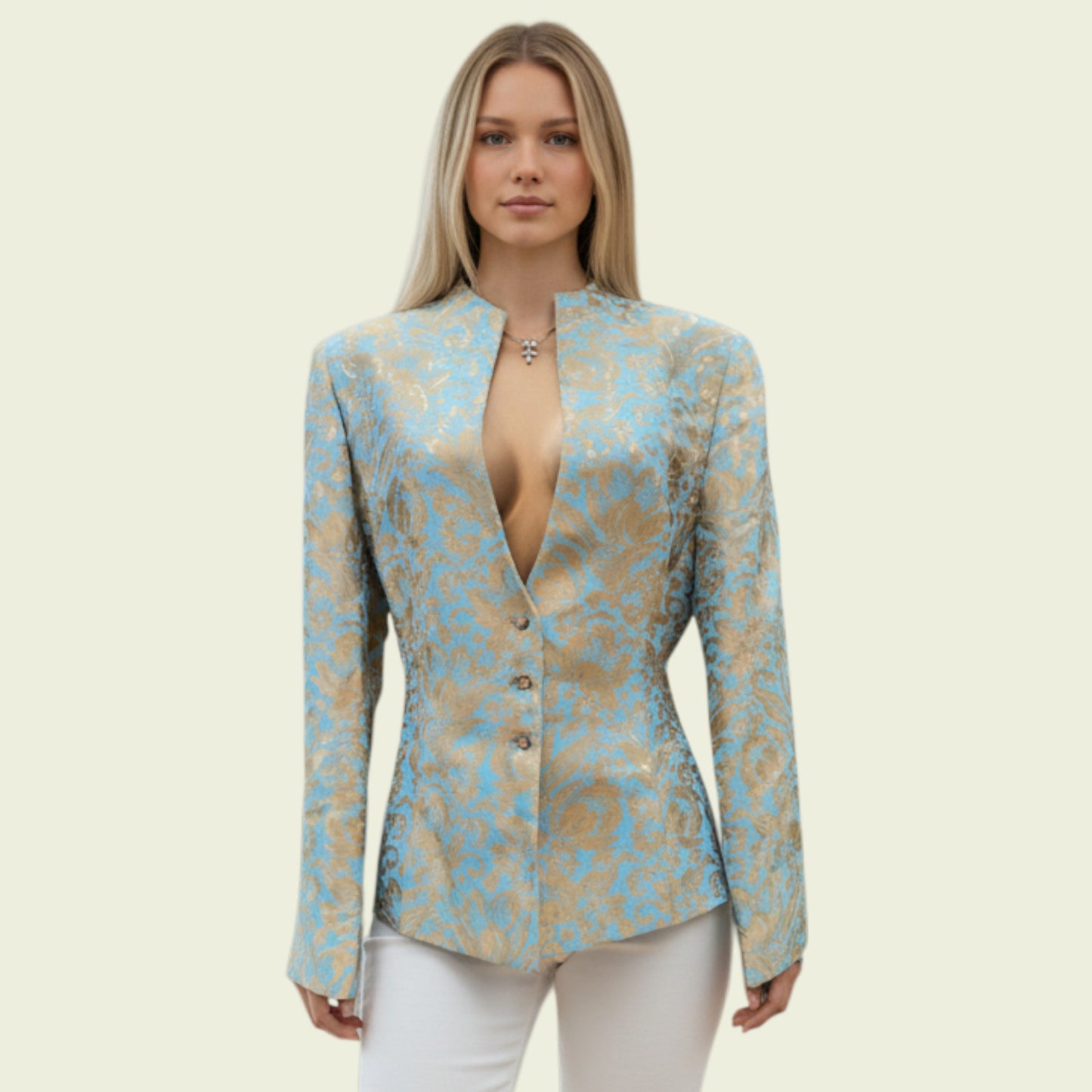 Model wearing a light blue and gold jacket on a beige background