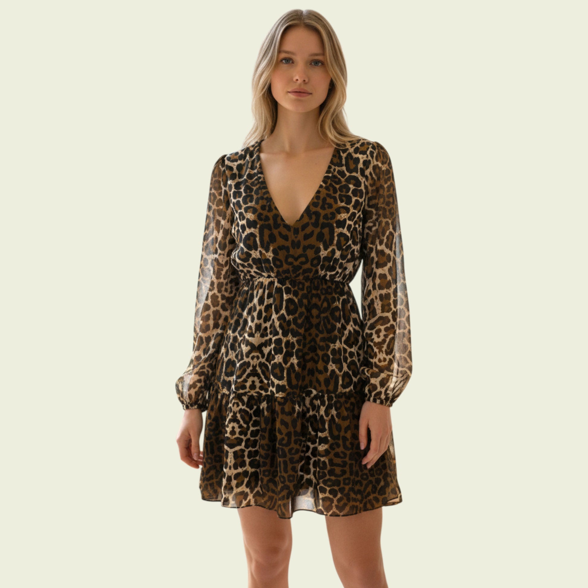 Model wearing animal print chiffon dress on beige background
