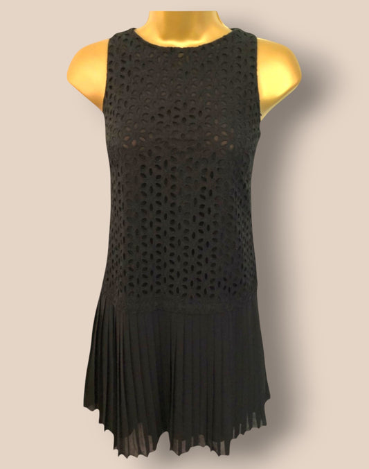 Black sleeveless dress on a mannequin against a beige background