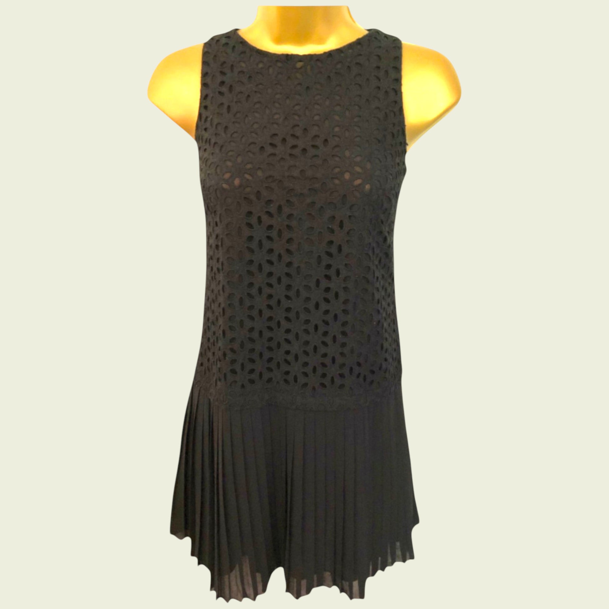 Black sleeveless dress on a mannequin against a plain background