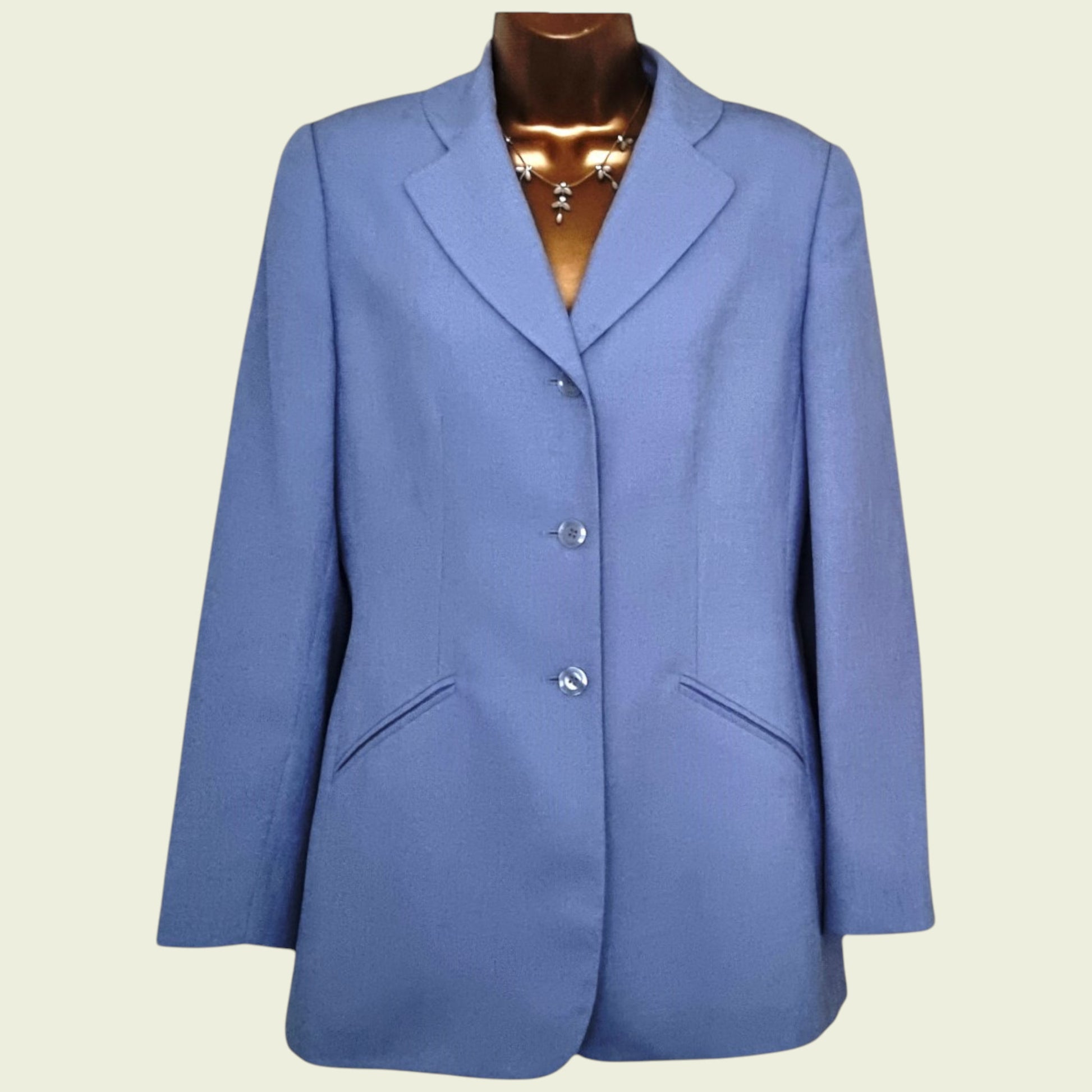 Blue blazer on a mannequin against a beige background