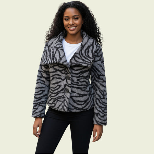 Woman wearing a zebra-patterned jacket on a beige background