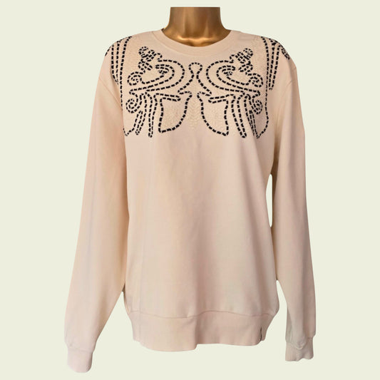Beige sweatshirt with brown floral embroidery on a mannequin against a beige background