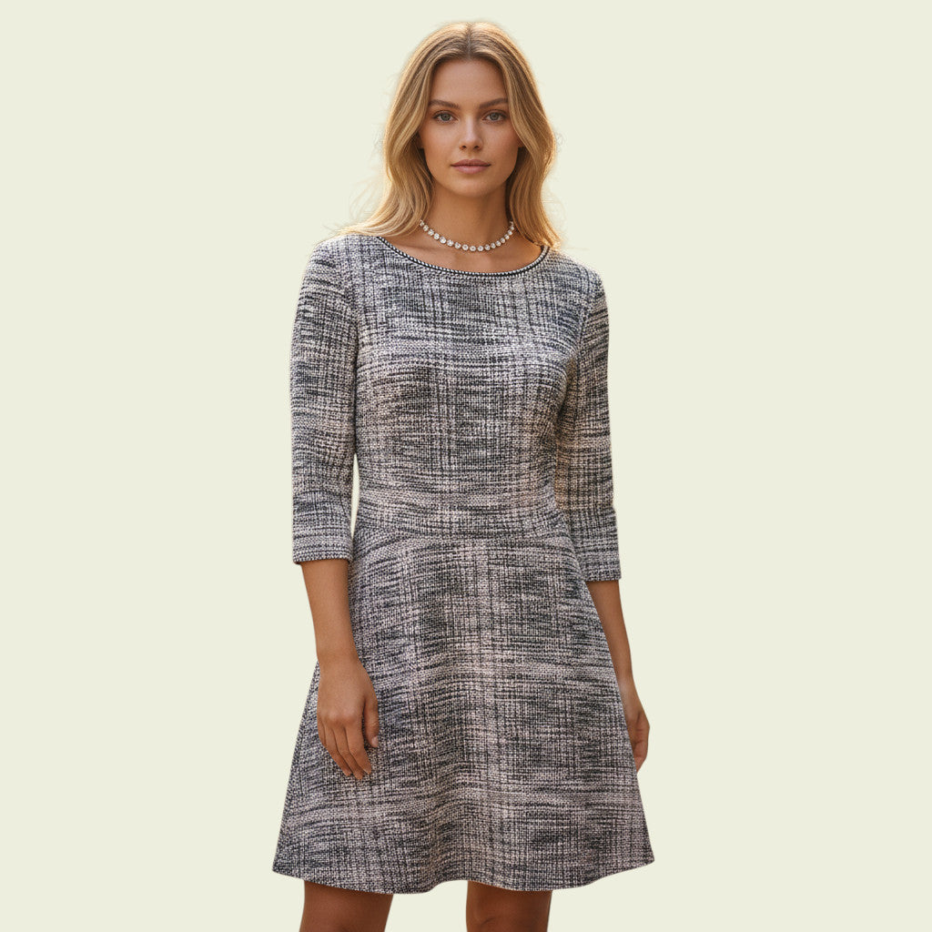 Woman wearing a patterned dress on a plain background