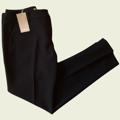 Black pants with a tag on a beige background