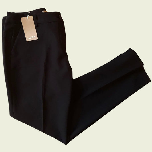 Black pants with a tag on a beige background