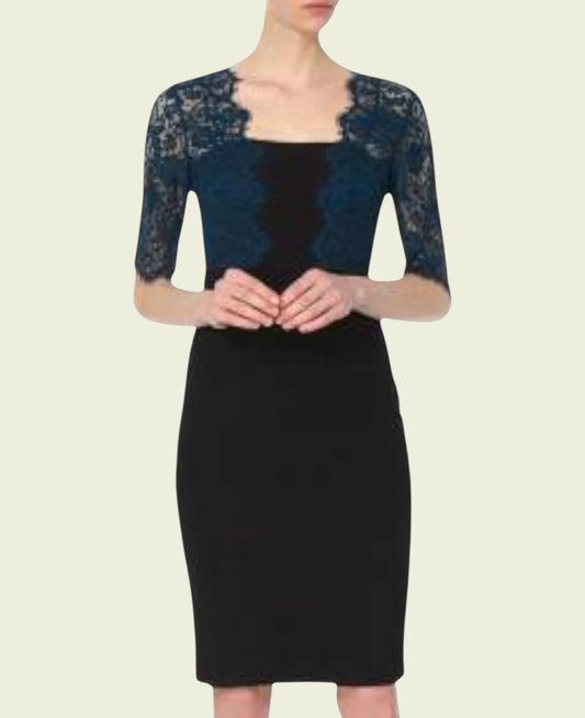 Model wearing black dress with teal lace bolero on beige background