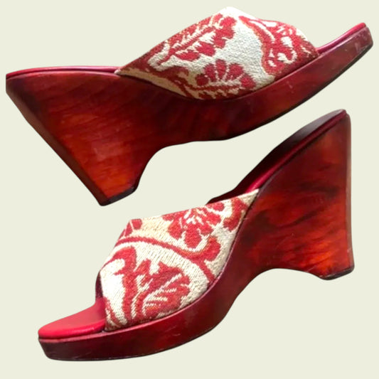 Red and white floral patterned shoes on a beige background