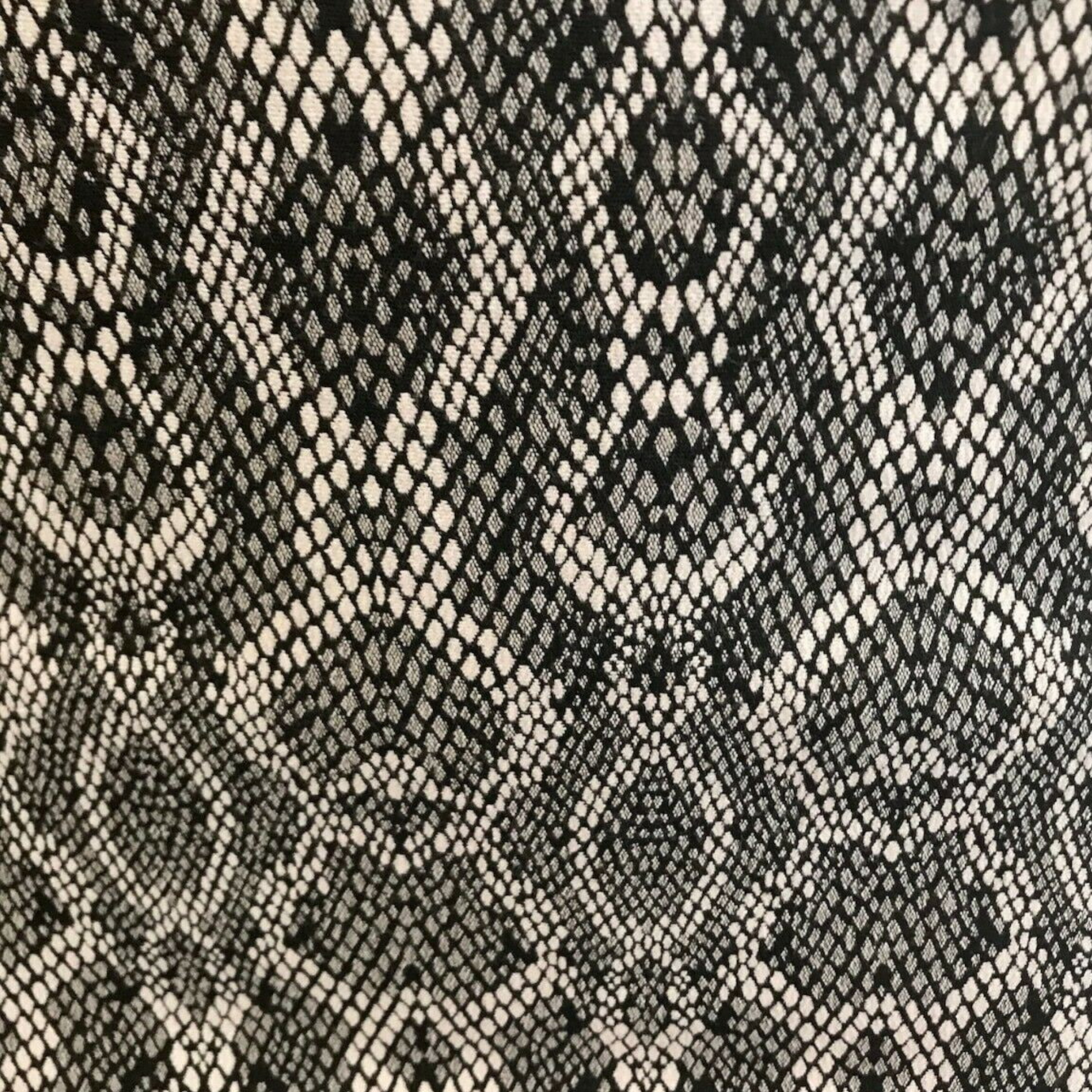 Patterned fabric with black and beige snake skin design