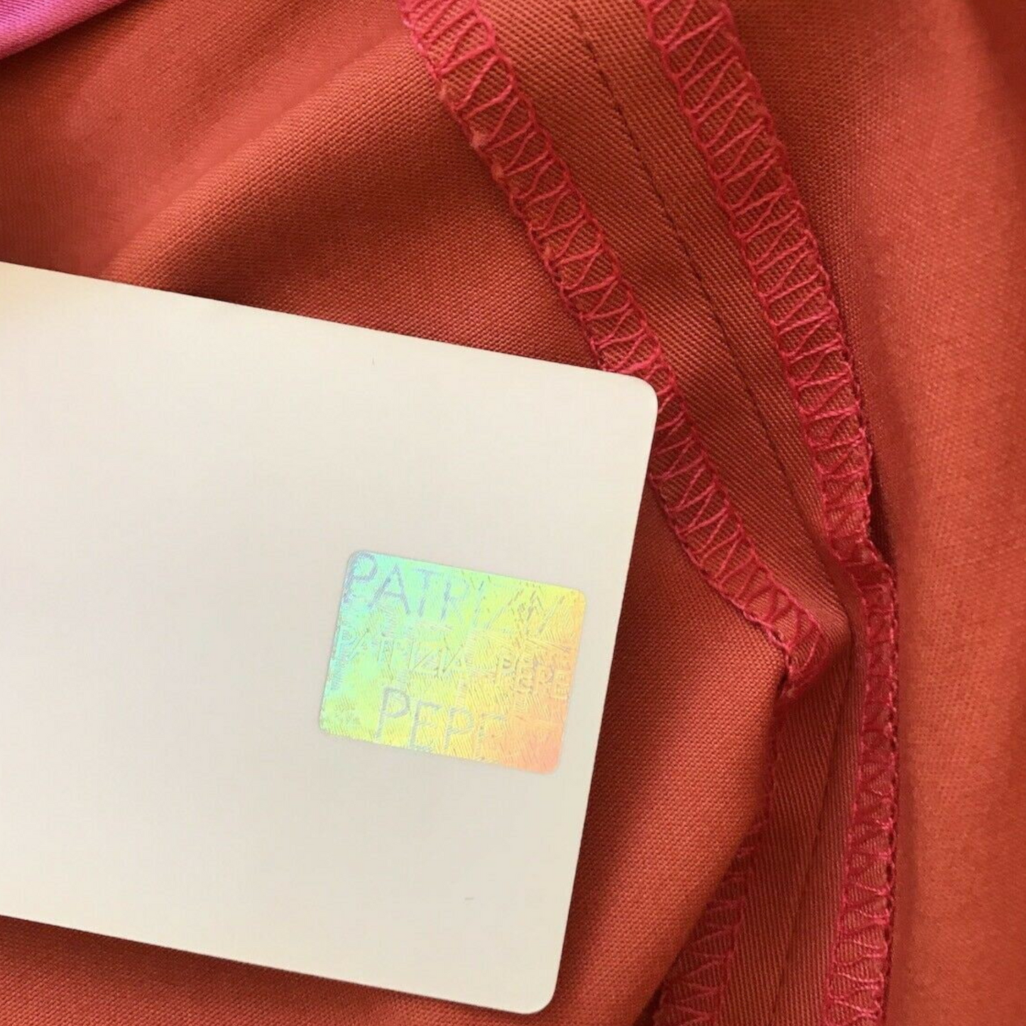 Close-up of a label on red fabric with 'PATH' branding.