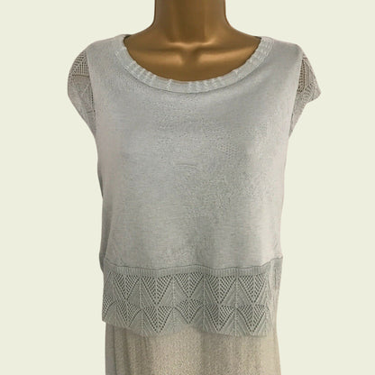Greens sleeveless top with lace detail on a mannequin against a beige background