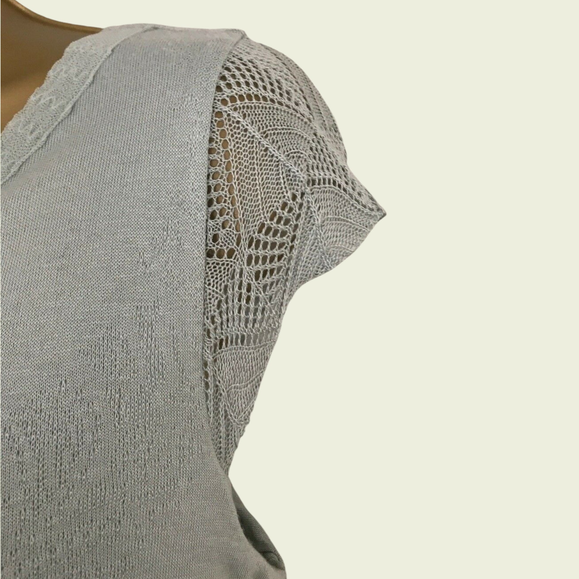 Green dress with lace detailing on a beige background