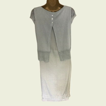 Green sleeveless top with textured trim on a mannequin against a white background