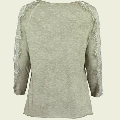 Light green long-sleeve top with lace detailing on a beige background
